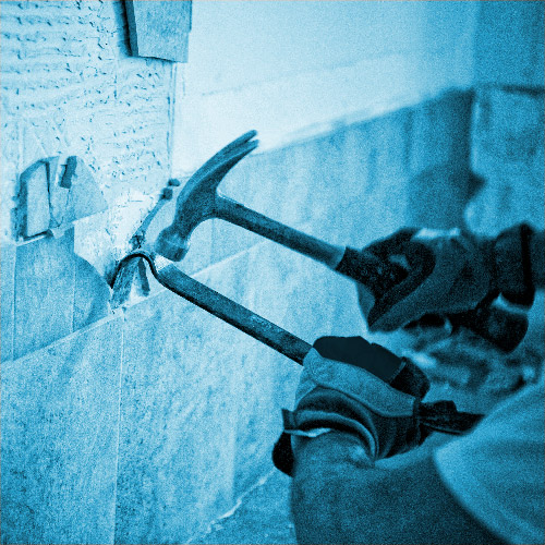 Binn Group Domestic graphic panel with a blue overlay. Person taking tiles off a wall