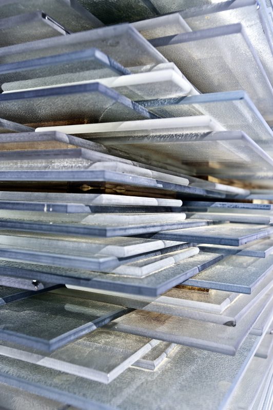 stacked scrapes of broken window pane glass ready to be recycled